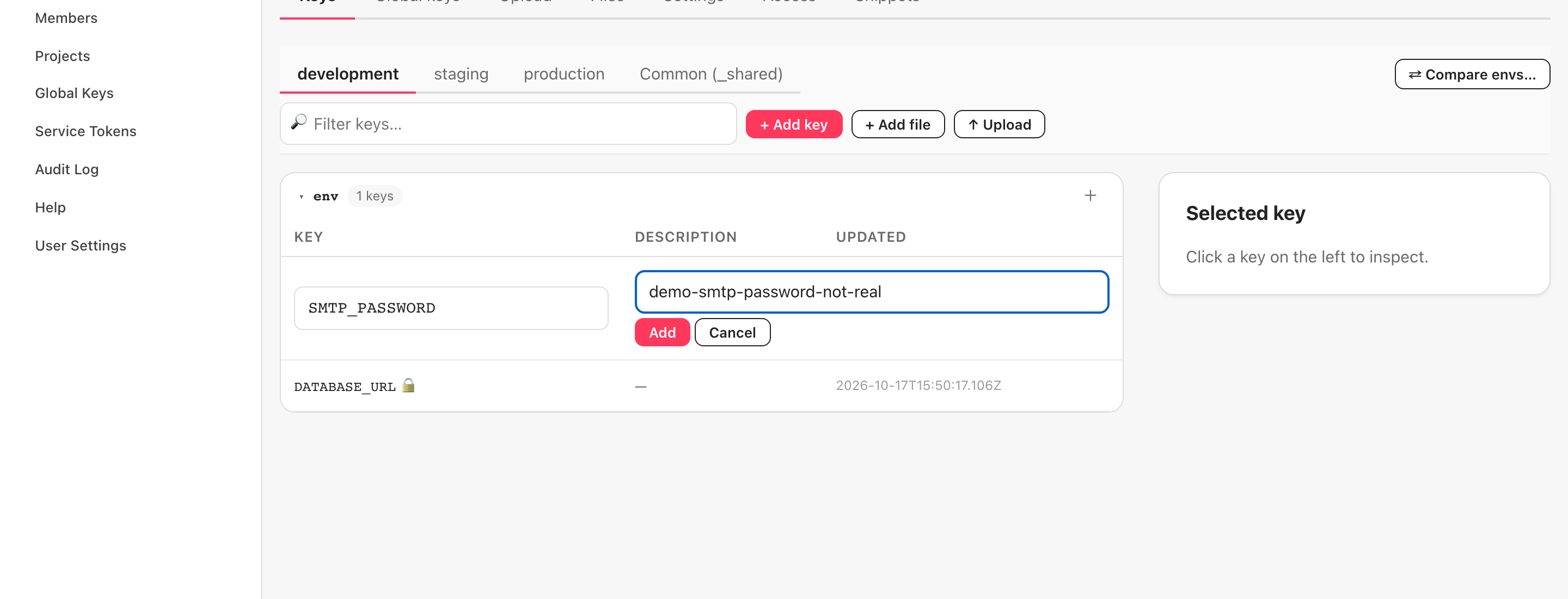 + Add key を押した後の Keys タブ（英語 UI）。一覧の先頭に Key name と Value の入力行が現れ、SMTP_PASSWORD と demo の値を入れた状態。行の下に Add と Cancel のボタン。先に入れた DATABASE_URL が下に見える。